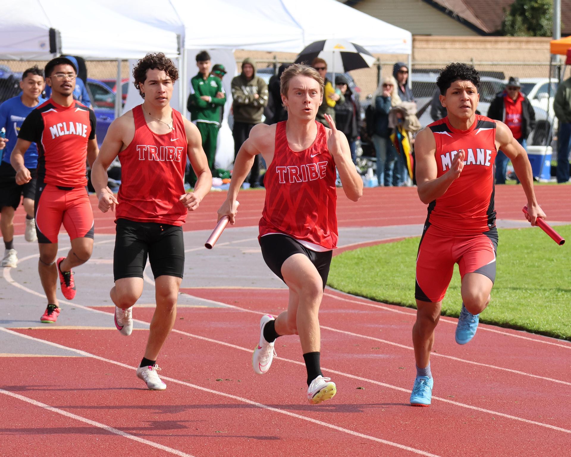 varsity boys running the four by 100 meter relay