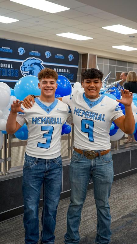 Dirks Soto and David Valdez pose for a photo while doing the Panther claw hand symbol.