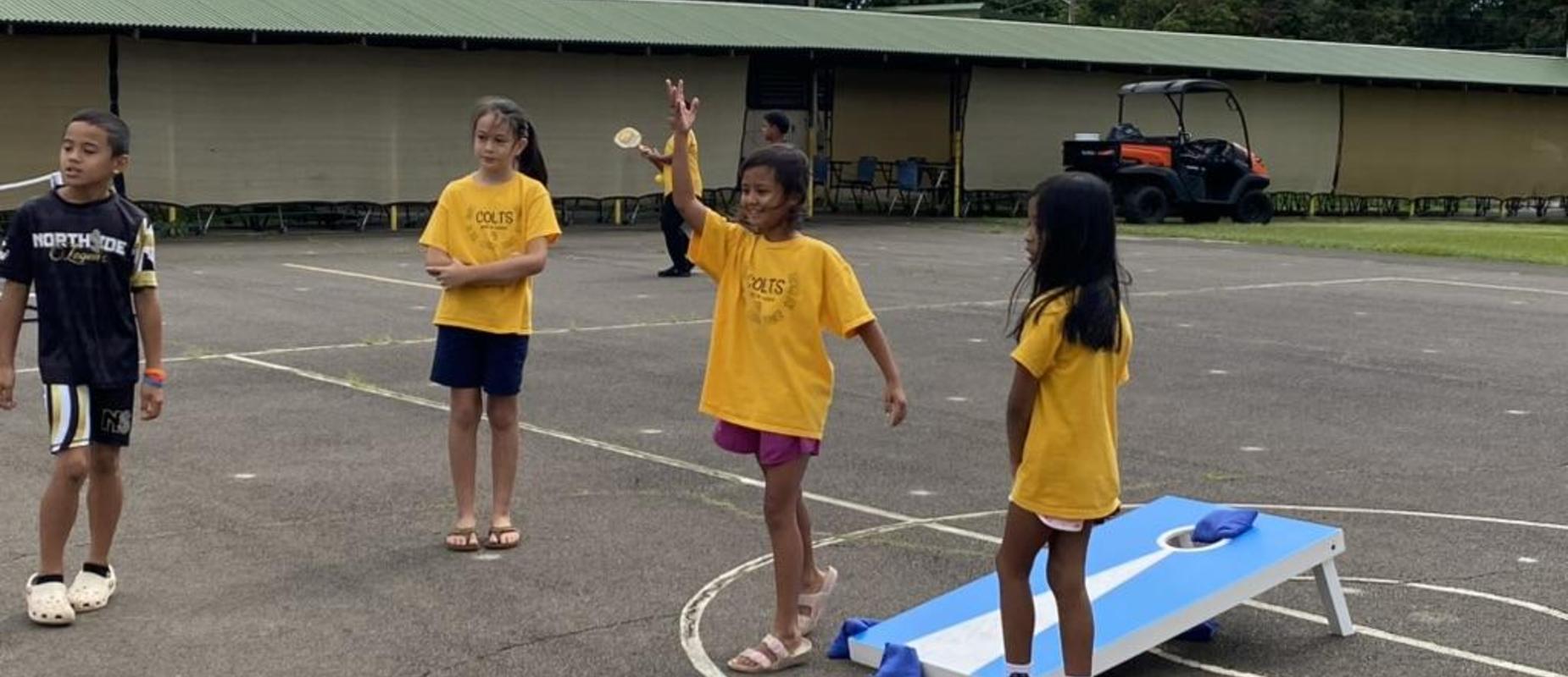 Students playing lawn games on the blacktop