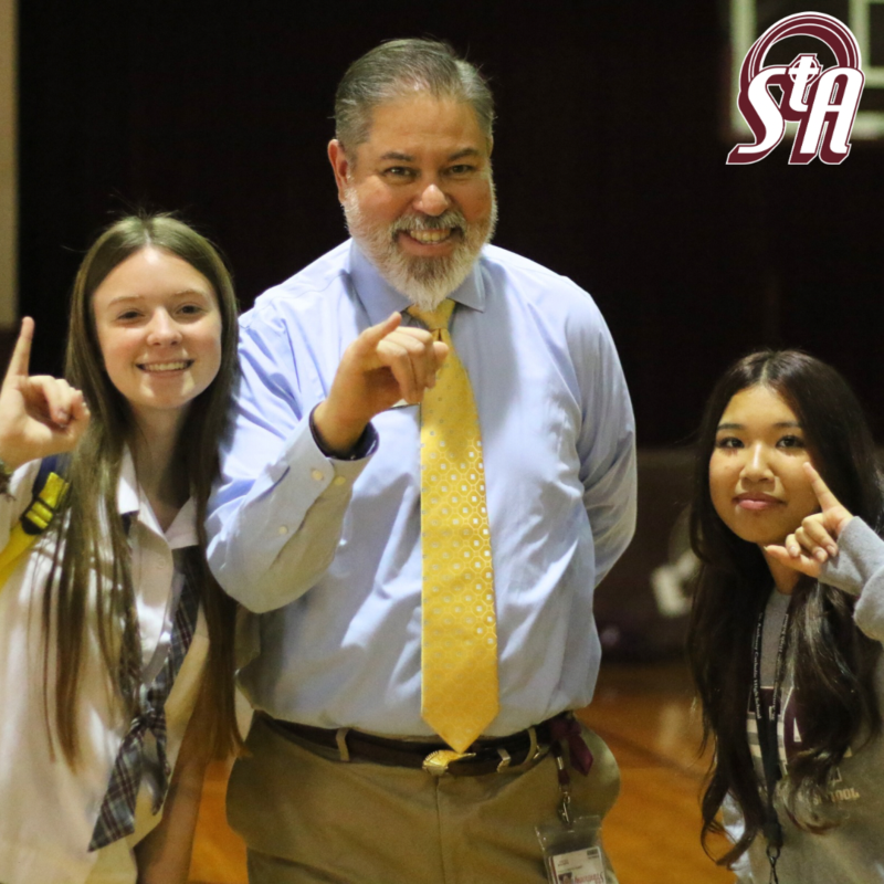 Students and teacher throw up the stinger pinky gesture for Sting’em