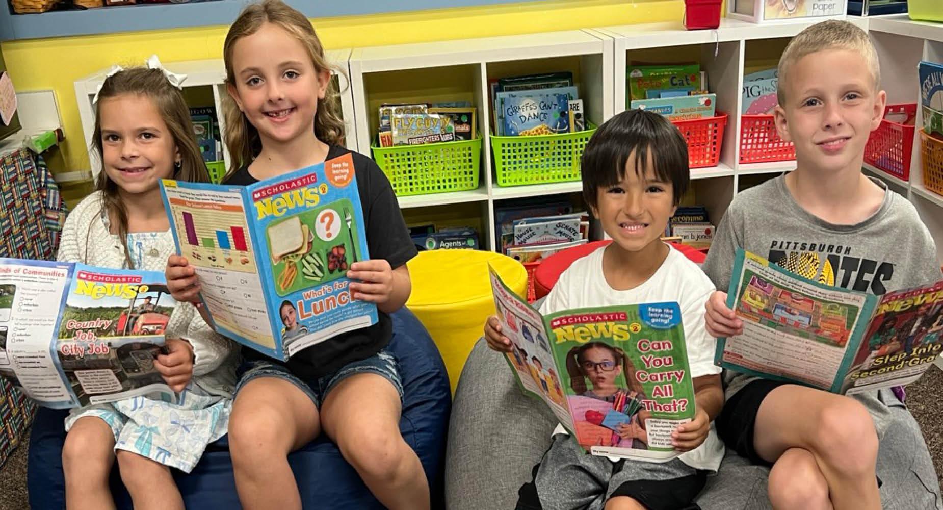 Sunrise Elementary students sit on beanbags and read magazines in Mrs. Gutwald's classroom