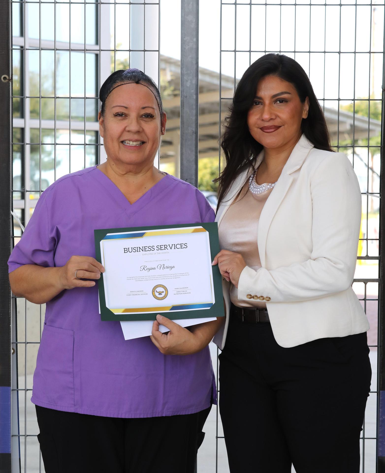 Picture of employee holding certificate 