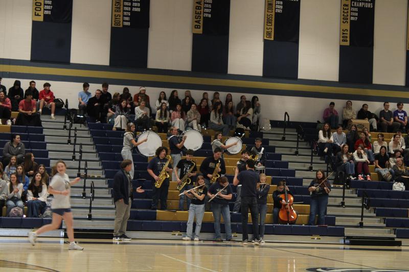 group of students in pep band sitting in stands