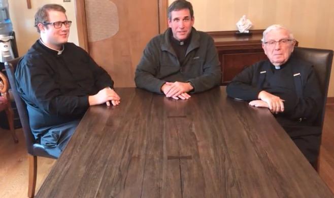 Fr. Matt, Fr. Larry, and Msgr. Mike address parishioners from the rectory during the shelter in place order in March 2020.