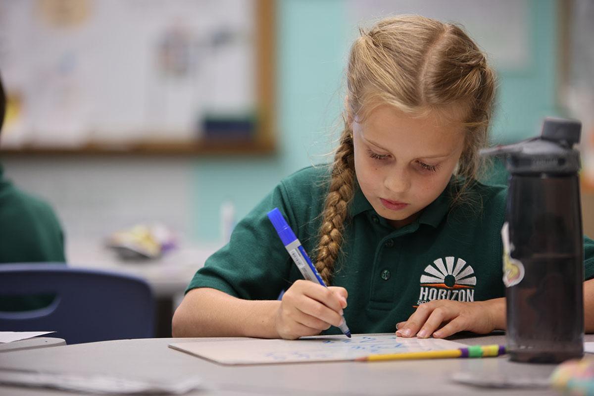 HSA Des Moines student working on a white board