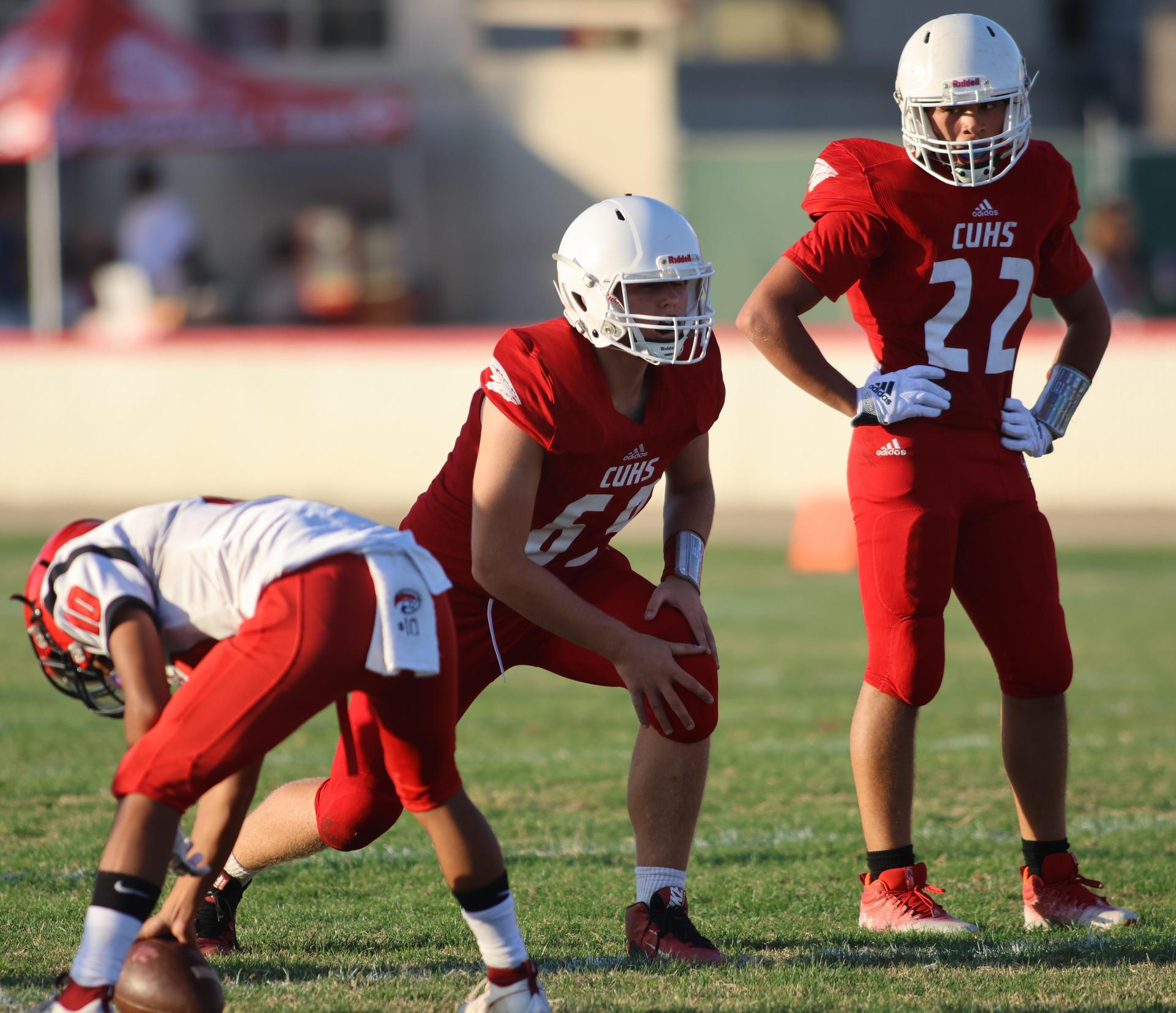 junior varsity football players in action against Fowler