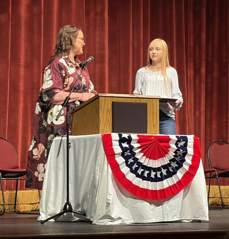 Student receiving award at a podium