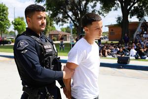 A Whittier Police officer detains a Santa Fe High School student portraying an impaired driver during the school’s “Every 15 Minutes” program on April 1.