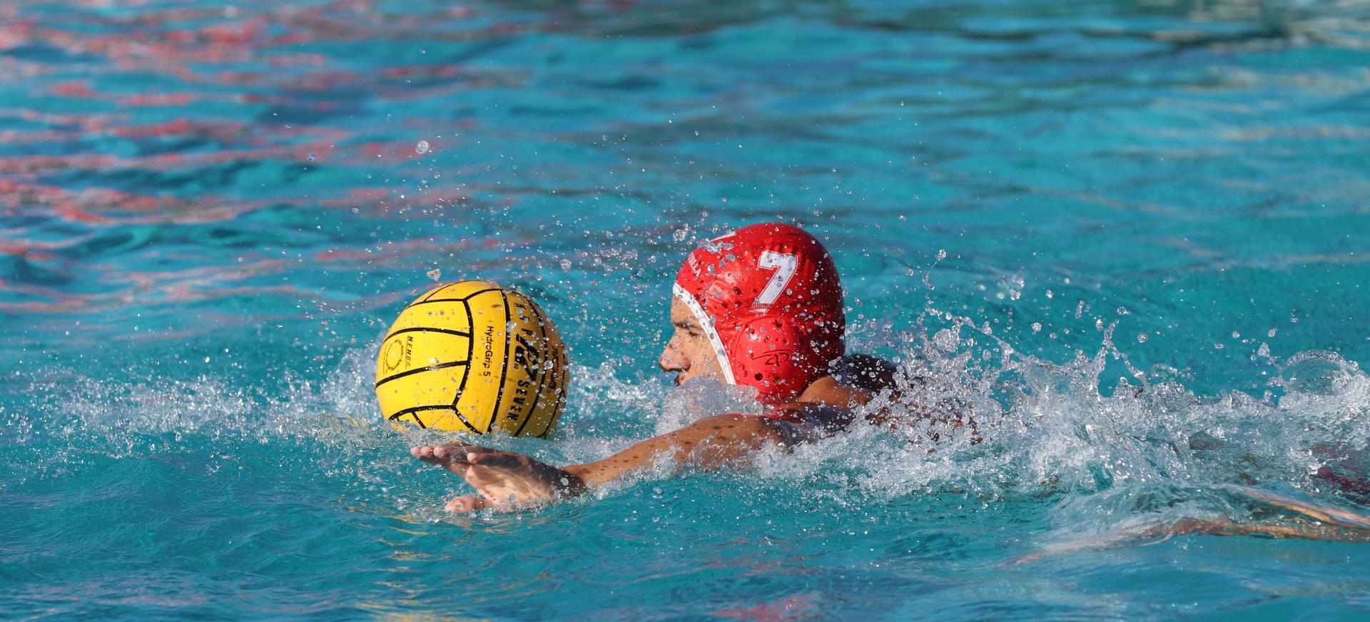 boys water polo players in action against san joaquin memorial