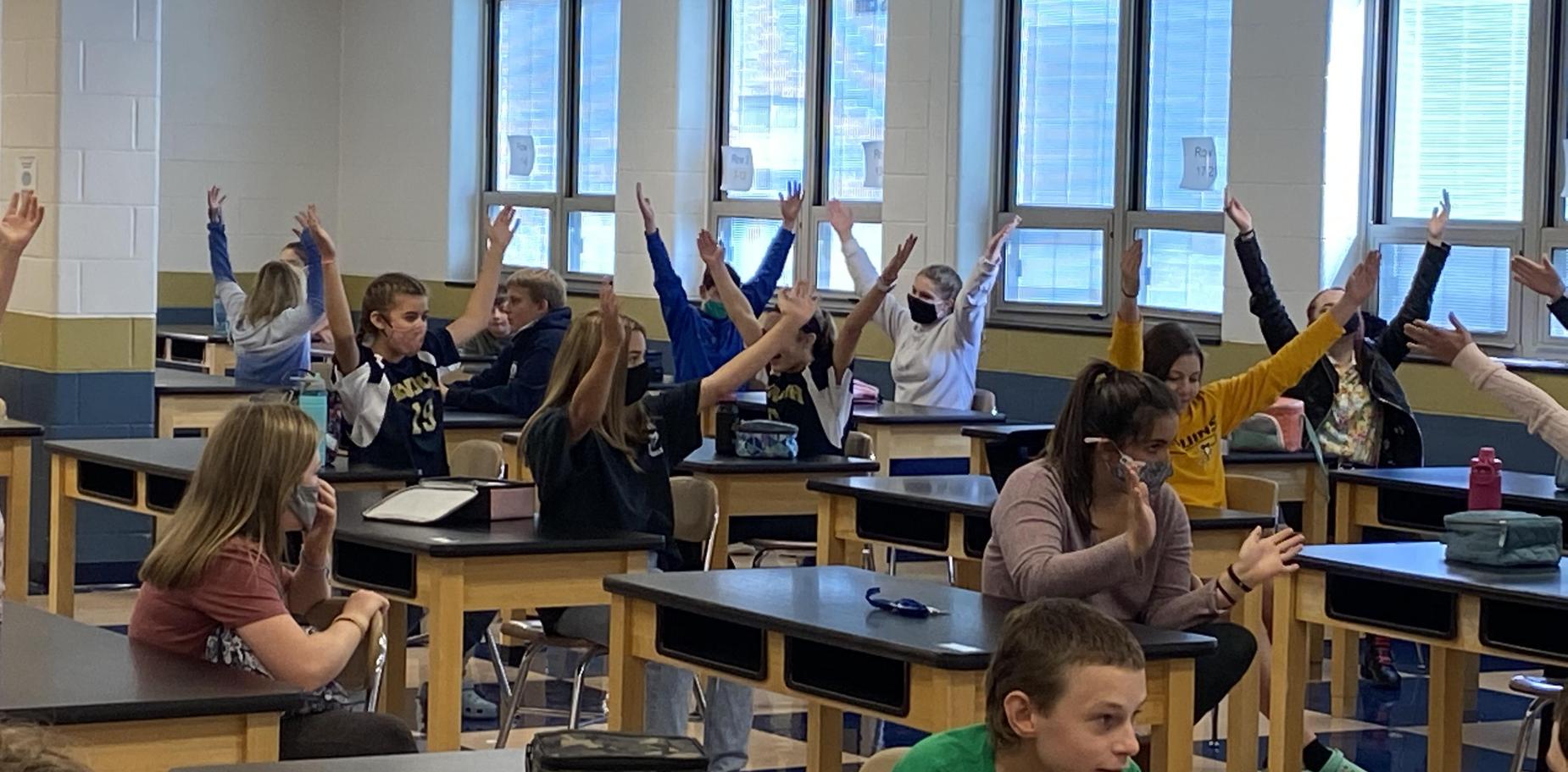 Kids doing the hand gestures to YMCA during lunch