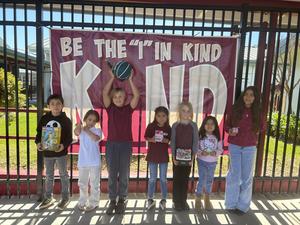 Students holding a toy