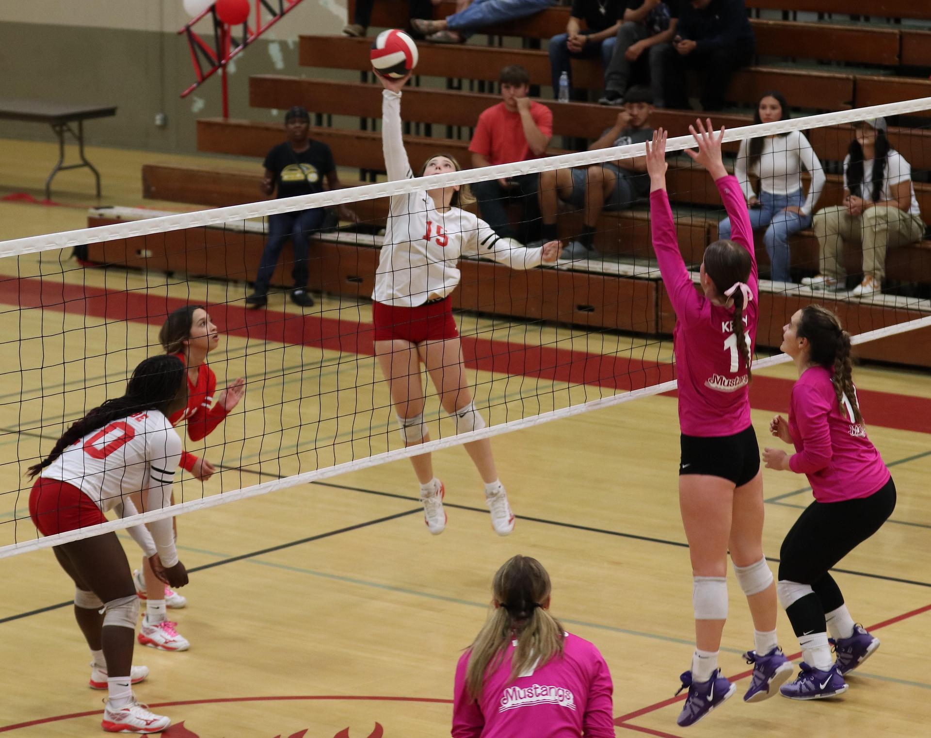 varsity volleyball players in action against Minarets