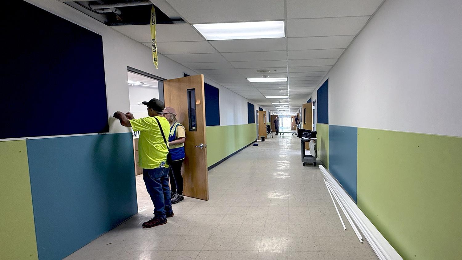 crew members installing room signs
