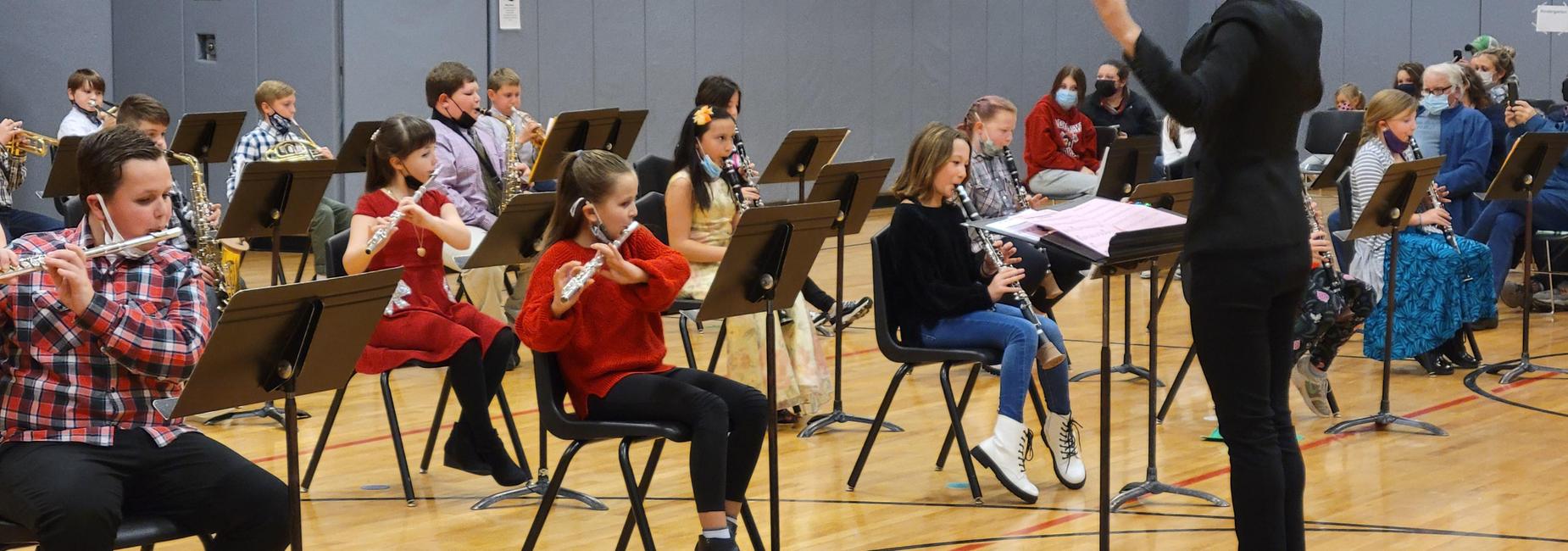 Mrs. Kogut and some of our LPQ Band students at the Winter Concert 2021