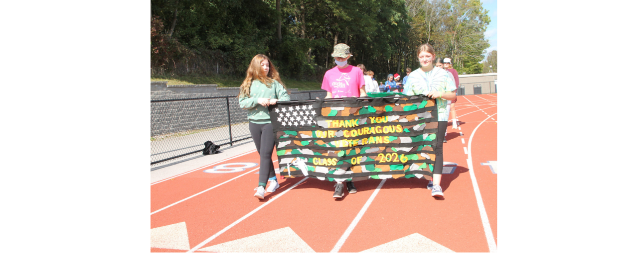 students carrying a banner