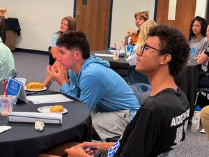 Students listening to guest speaker during Big Cat Council meeting
