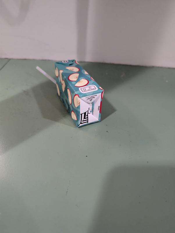Empty juice box left on counter