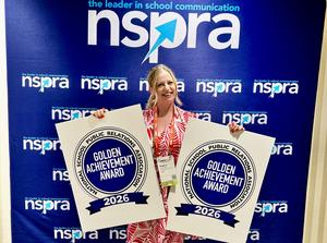 Happy and proud woman stands holding two awards for NSPRA