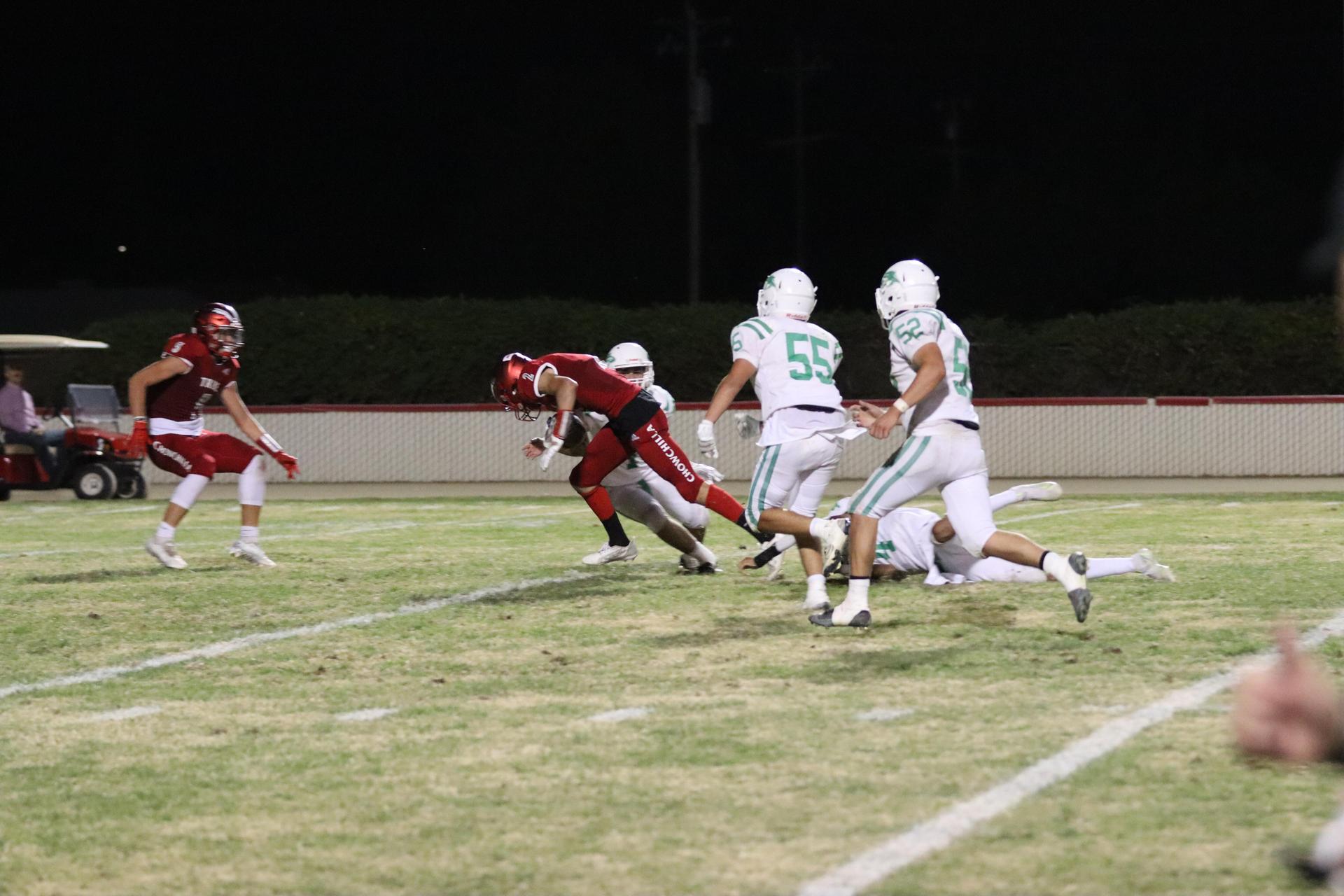 varsity football players in action against Riverdale