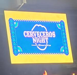 Sign that reads 'Cerveceros Night' with decorative border.