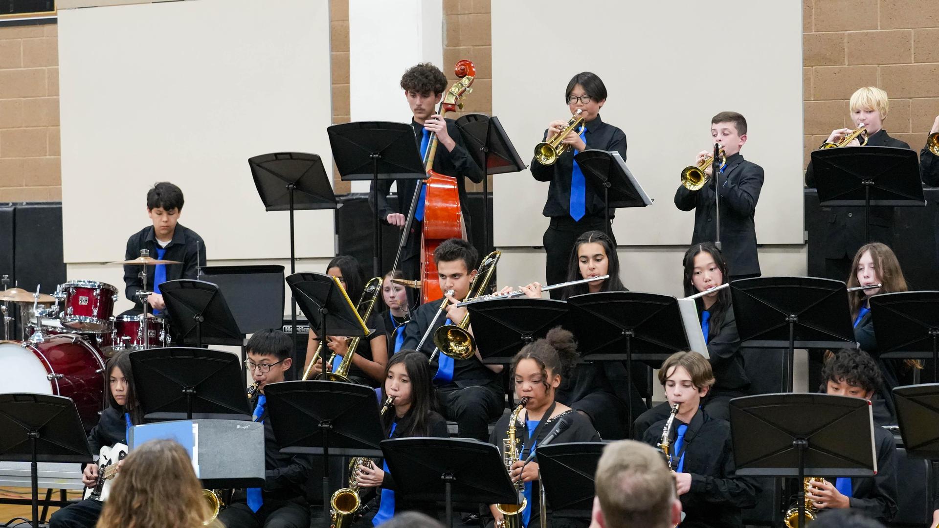 Students playing instruments on a stage for band