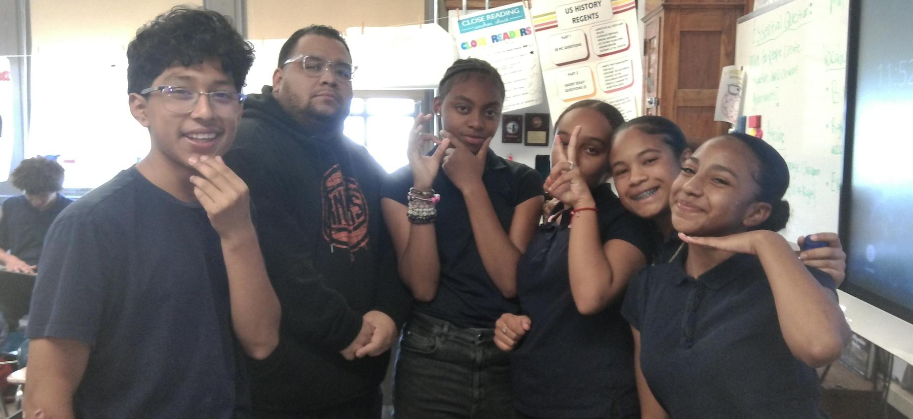8th graders pose with one of their favorite teachers