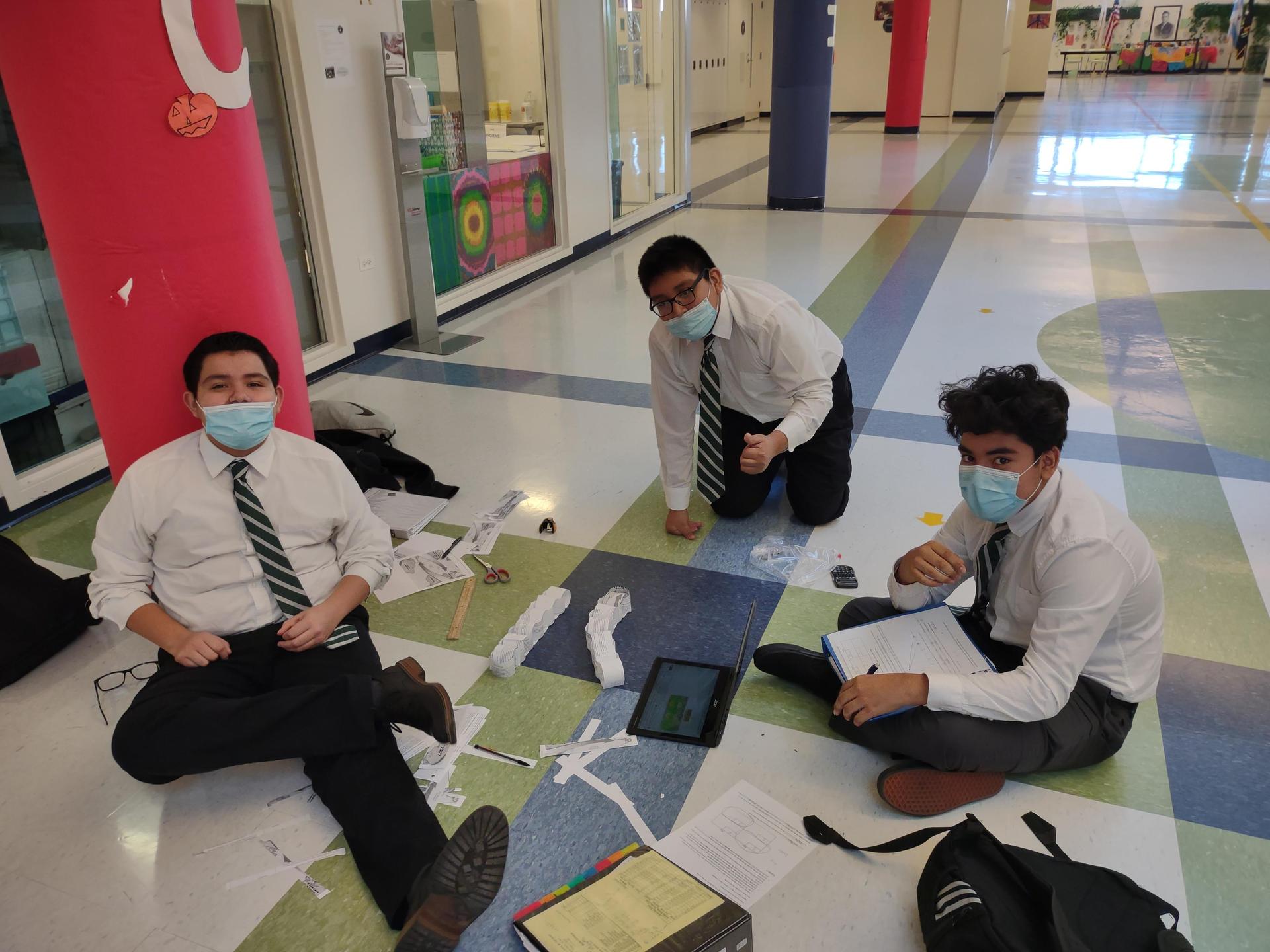 Christopher Hernandez, Alejandro Silva and Adolfo Soriano apply their learning about comparative advantage and specialization towards a group project in Human Geography