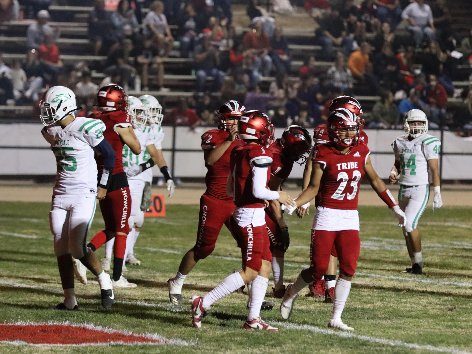 varsity football players in action against Riverdale
