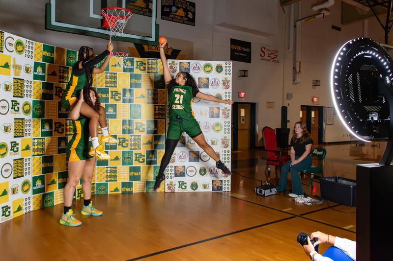 Students in Prince George High School's sports management class take promotional photos of athletes during winter sports media day.