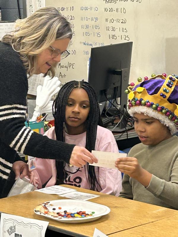 Teacher and a student wearing a crown