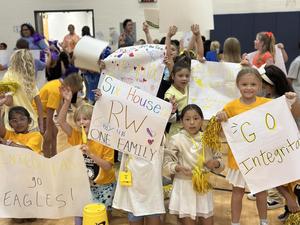 Students in yellow house cheering on their new house mates.