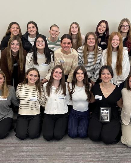 Group photo of female students posing together, including award recipients.