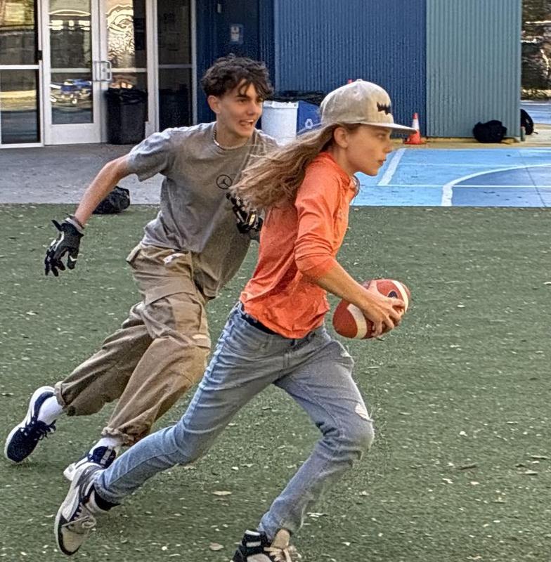Two boys playing flag football