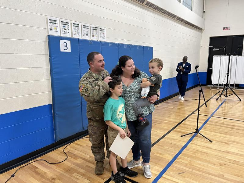 Soldier and family reunite in school gym