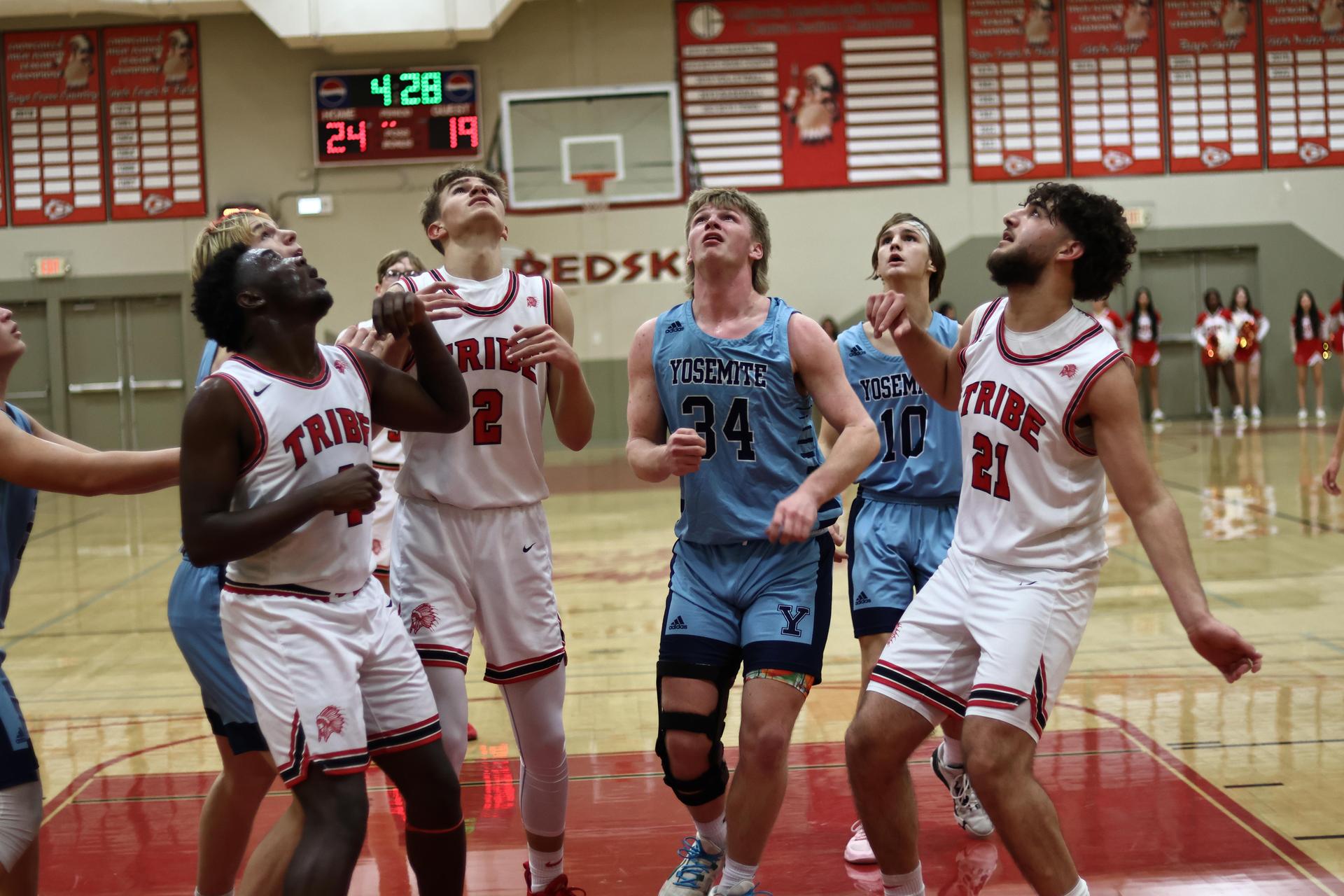 Varsity boys playing basketball against yosemite