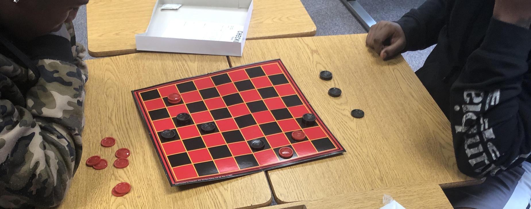 Students playing Checkers!