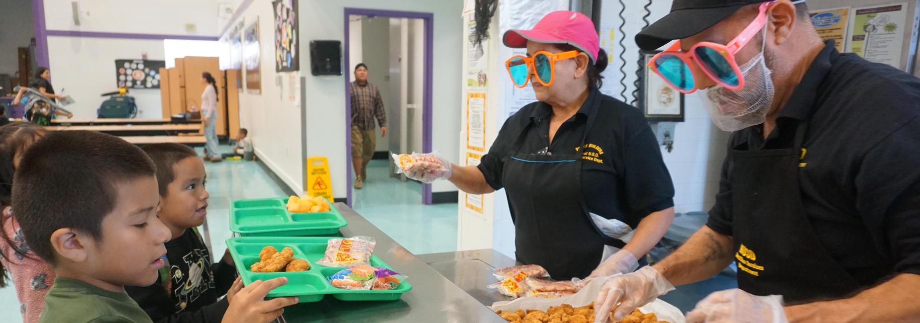 Children being served food in the cafeteria