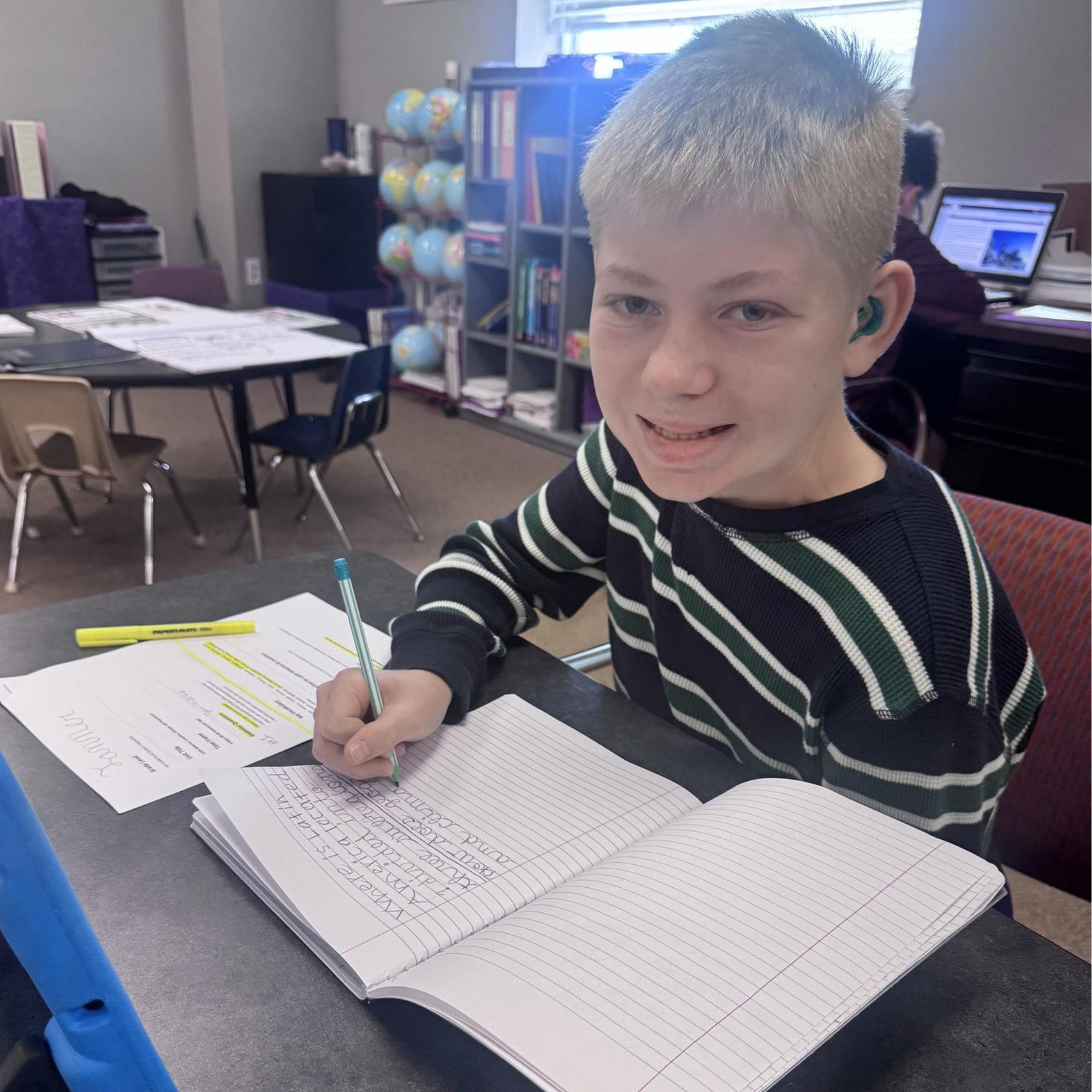Boy writing in a journal