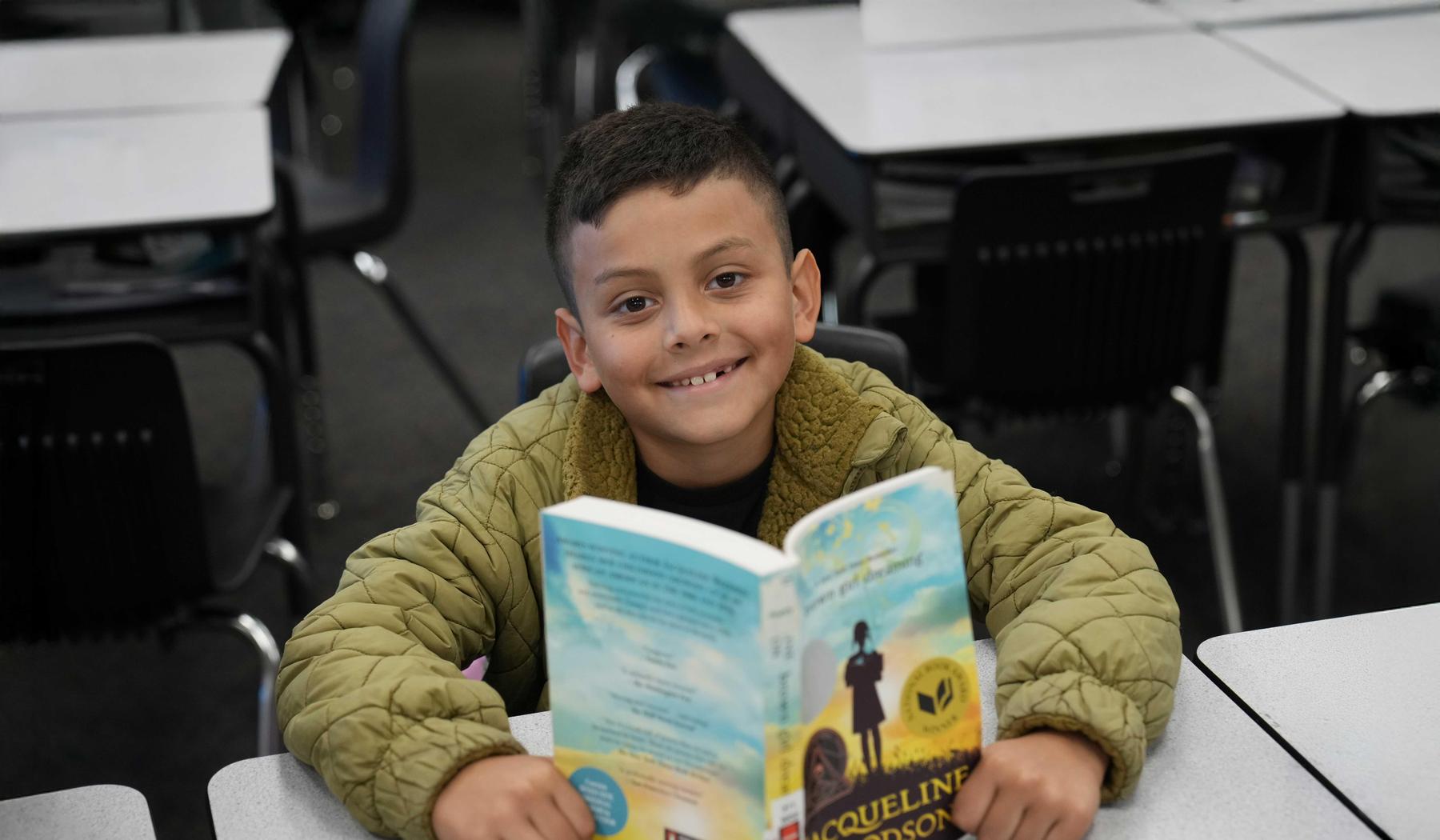 Smiling Boy reading a book