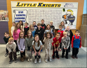 smiling group of children in rows standing in front of gridded board