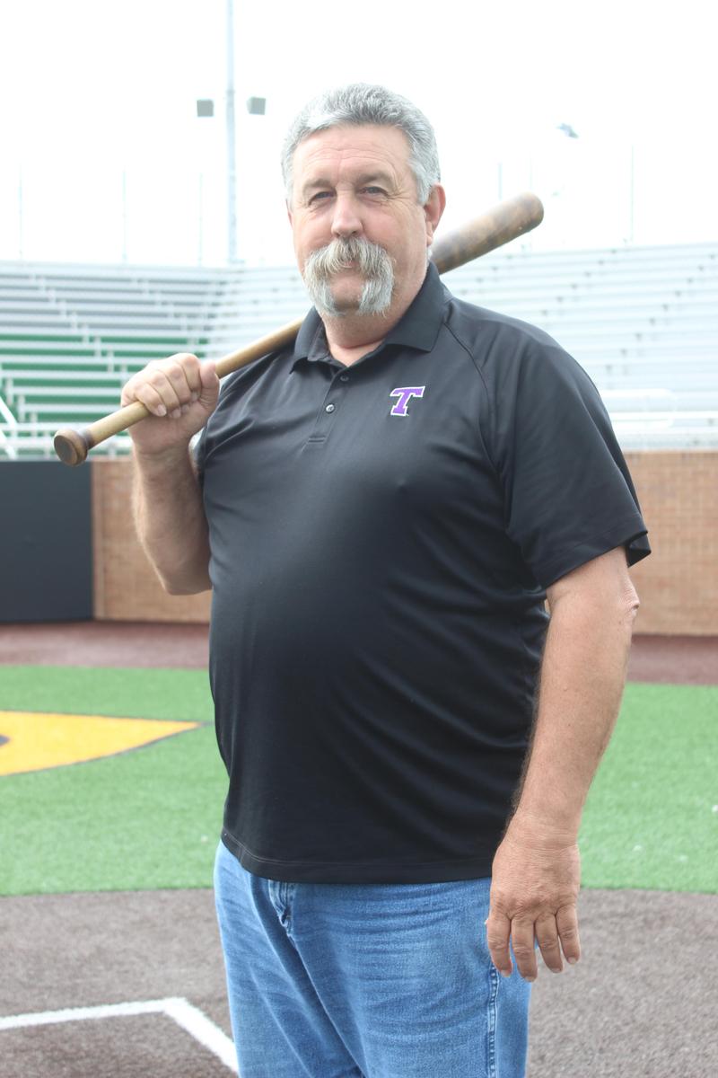 CHS teacher Dwayne Griffith holding a baseball bat