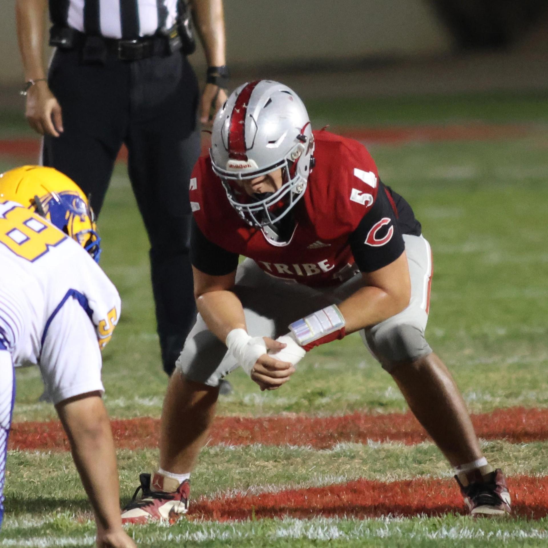 Varsity football players in action against Parlier 137