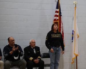 Army veteran Liz Johnson salutes when introduced