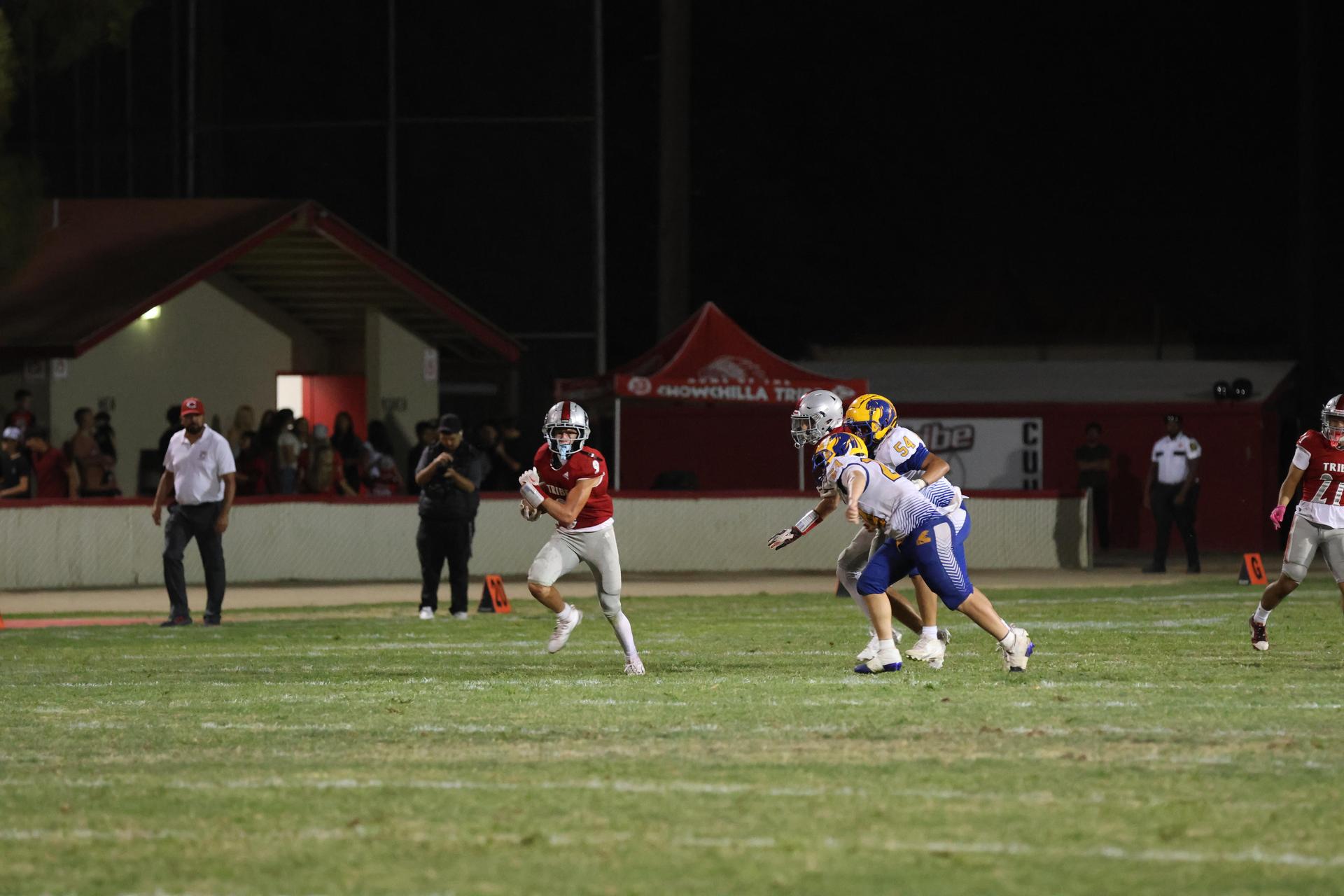 Varsity football players in action against Parlier 22