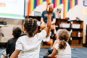 student raising hand in class