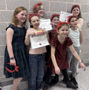 A team of elementary students posing with certificates at the Odyssey of the Mind competition.