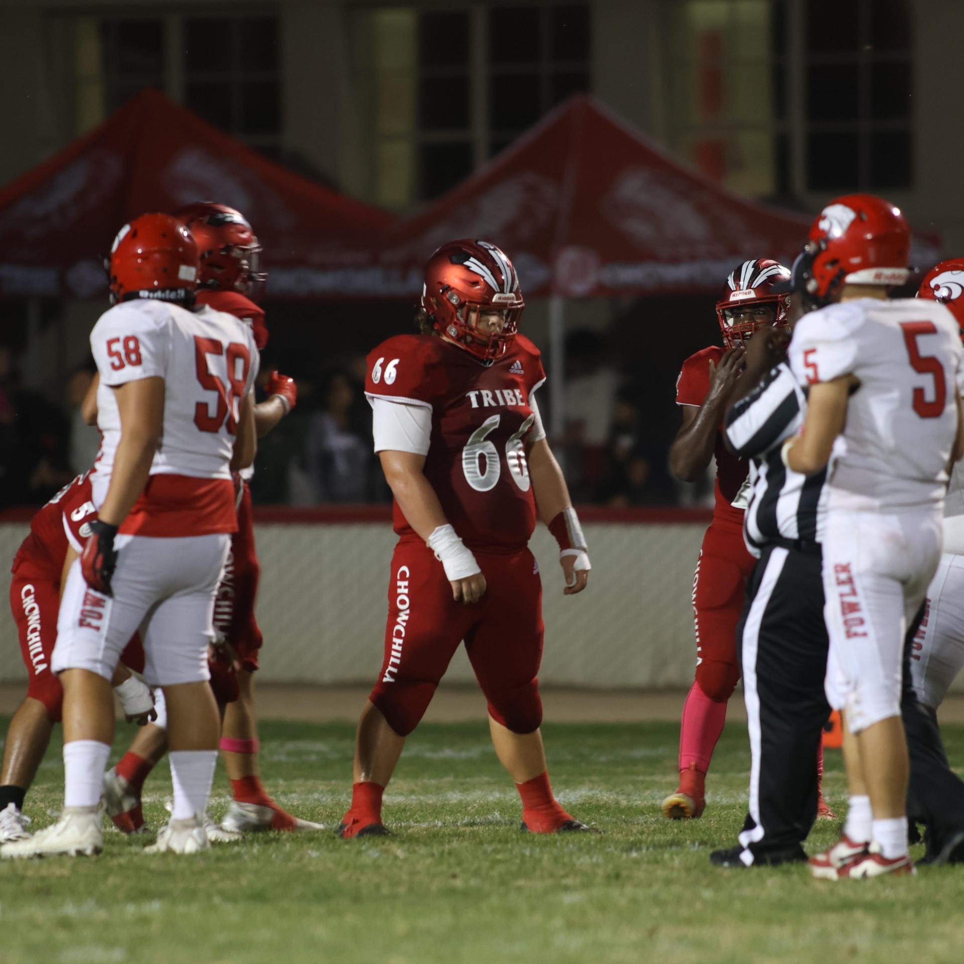 varsity boys playing football against Fowler
