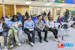 Parents supporting the ribbon cutting
