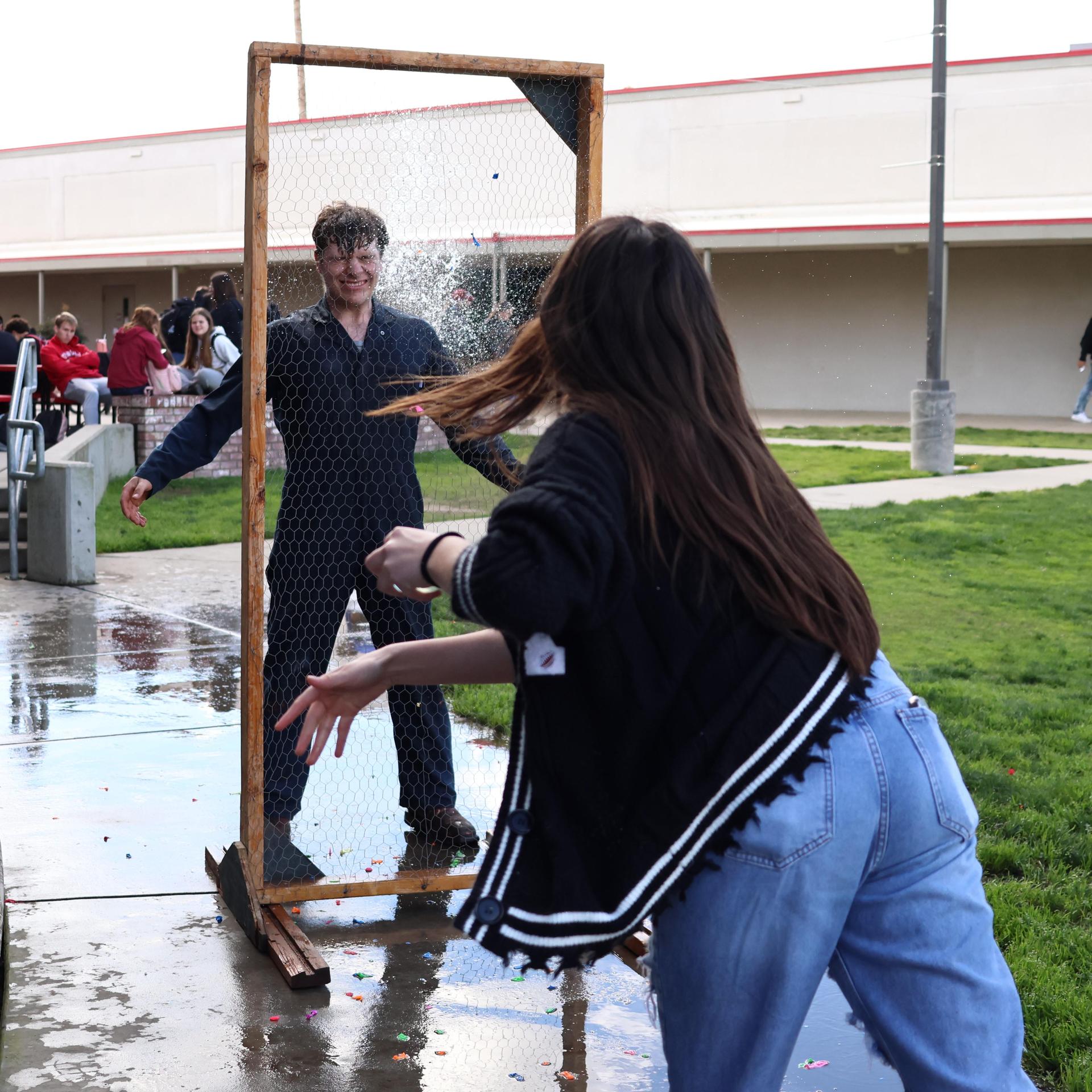 students and staff enjoying the water balloon toss