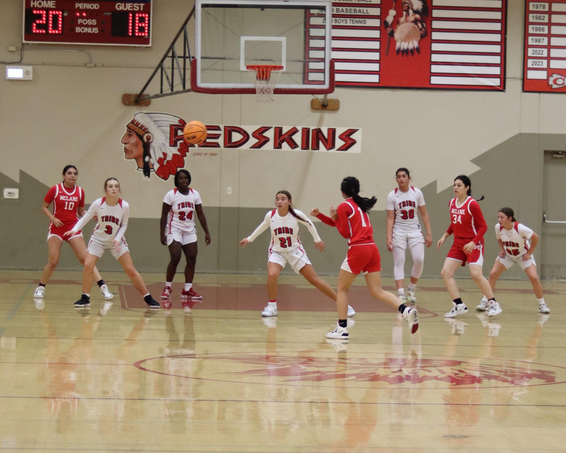 varsity girls playing basketball against mclane